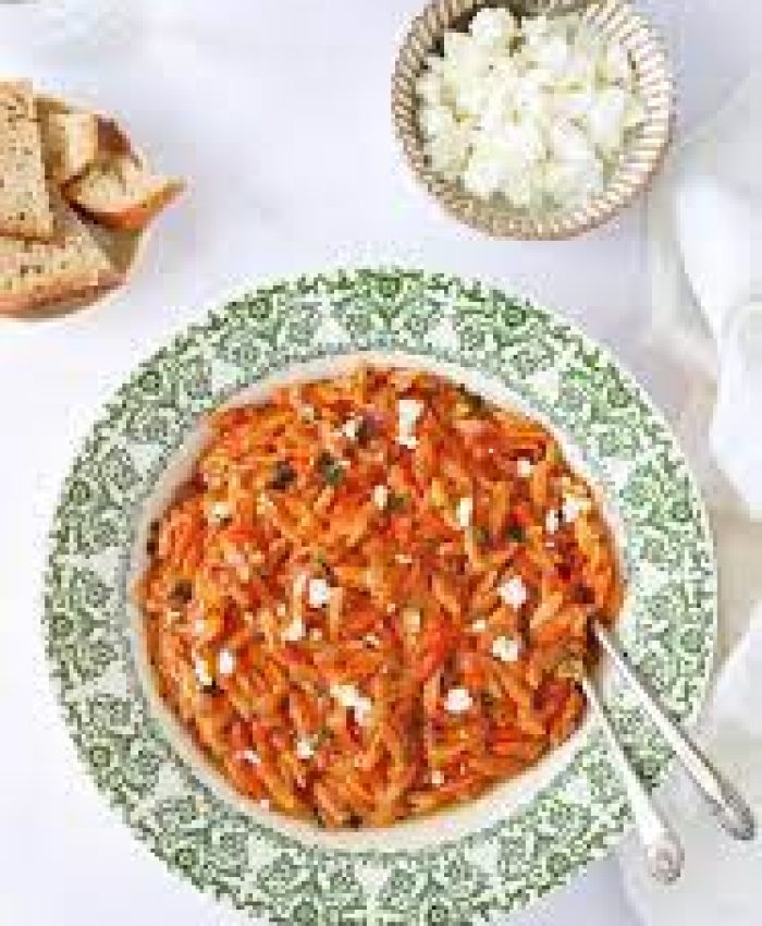 Kritharaki. Pasta in tomatoes.